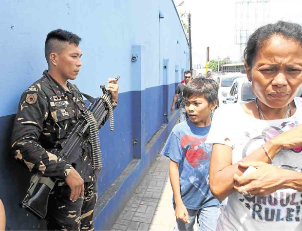 THE IMPACT of the Sept. 2 bombing in Davao City is being felt far beyond Mindanao as security forces, like this soldier in Cebu City, were put on alert for terror threats. More soldiers guard crowded areas, like bus terminals, airports and seaports, and key installations.          JUNJIE MENDOZA/CEBU DAILY NEWS