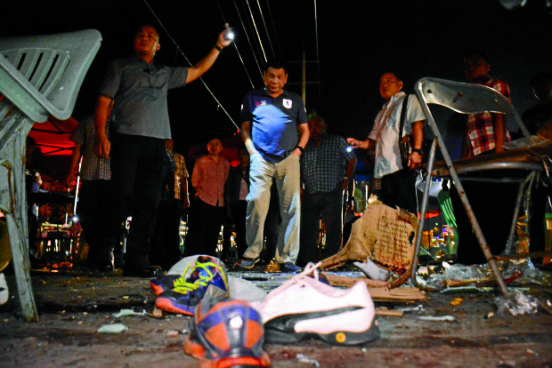 BLAST SITE  President Duterte visits the night market on Roxas Avenue in Davao City where 14 people were killed and 68 others injured after an explosion tore through what Davaoeños call their happy place.    Malacañang photo