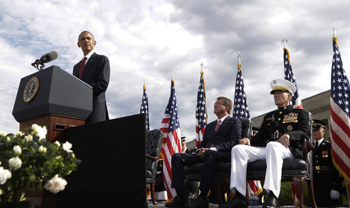 President Barack Obama speaks at a memorial observance ceremony at the Pentagon, Sunday, Sept. 11, 2016, to commemorate the 15th anniversary of the Sept. 11 attacks. With the president are Defense Secretary Ash Carter and Chairman of the Joint Chiefs of Staff Gen. Joseph Dunford, right. (AP Photo/Manuel Balce Ceneta)
