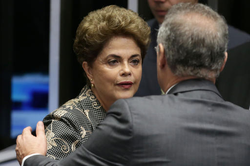 Brazil's suspended President Dilma Rousseff, greets Brazil's Senate leader Renan Calheiros, during her impeachment trial, in Brasilia, Brazil, Monday, Aug. 29, 2016. Rousseff is on trial for breaking fiscal rules in her management of the federal budget. In May, the Senate voted to impeach and suspend her. Rousseff denies wrongdoing. (AP Photo/Eraldo Peres)