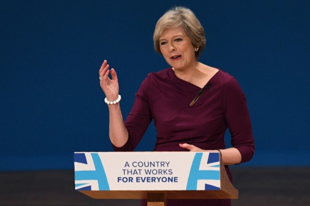British Prime Minister Theresa May delivers a keynote address on the final day of the annual Conservative Party conference at the International Convention Centre in Birmingham, central England, on October 5, 2016.  Brexit prompted the resignation of the UK's prime minister and the reshaping of the country's government, but the ruling Conservative Party has already rebounded and is showing a united front. The jubilant mood at the annual Conservatives conference is being led by its hardline eurosceptics -- for years the awkward squad within the party.  / AFP PHOTO / PAUL ELLIS