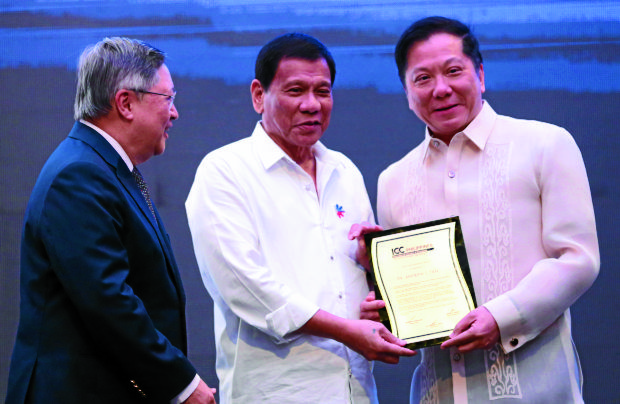 Andrew Tan of Megaworld received the  ICCP  Global Excellence Award  from  PRRD, department of finance Carlos Sonny  Dominguez, DTI Sec Lopez. PHOTO BY JOAN BONDOC