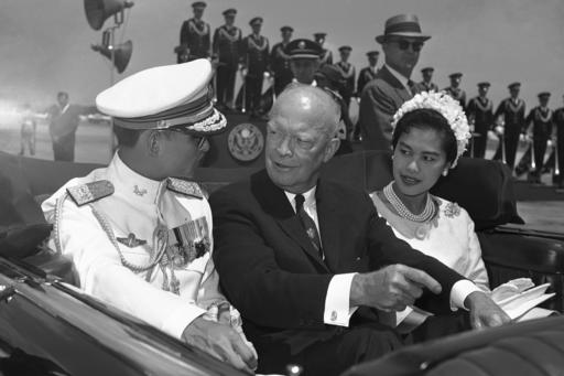 FILE - In this June 28, 1960, file photo, U.S. President Dwight Eisenhower, center, is seated between Thailand's King Bhumibol Adulyadej, left, and Queen Sirikit for a motorcade drive from National Airport to the White House in Washington. Thailand's Royal Palace said on Thursday, Oct. 13, 2016, that Thailand's King Bhumibol Adulyadej, the world's longest-reigning monarch, has died at age 88. (AP Photo, File)