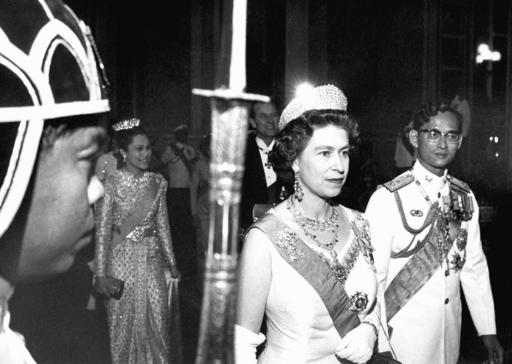 FILE - In this Feb. 11, 1972, file photo, Britain's Queen Elizabeth II walks with Thailand's King Bhumibol Adulyadej, right, with Queen Sirikit at rear left and Prince Philip at rear right, in Bangkok. Thailand's Royal Palace said on Thursday, Oct. 13, 2016, that Thailand's King Bhumibol Adulyadej, the world's longest-reigning monarch, has died at age 88.  (AP Photo, File)