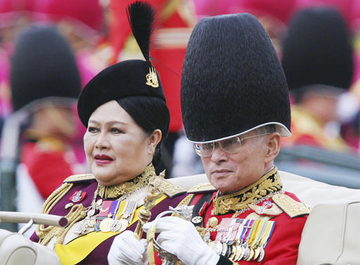 FILE - In this Dec. 2, 2005, file photo,Thailand's King Bhumibol Adulyadej and Queen Sirikit review the honor guard during a ceremony ahead of his 78th birthday in Bangkok. Thailand's Royal Palace said on Thursday, Oct. 13, 2016, that Thailand's King Bhumibol, the world's longest-reigning monarch, has died at age 88.  (AP Photo/Sakchai Lalit, File)