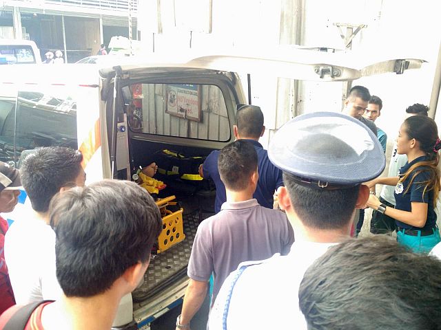 Cargo forwarding firm courier Juan Amistad Udto is loaded into an ambulance after he was injured in an accident at the cargo elevator of the Elizabeth Mall in Cebu City, on Oct. 17, 2016. (CDN/ CHRISTIAN MANINGO)