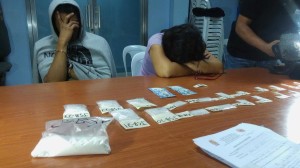 Jesryl Bacalla and wife Jean, hide their faces, after they are caught with P5.9M shabu during a police drug bust in Cebu City.  Bacalla is suspected to be a drug runner in Rolando "Kerwin" Espinosa Jr.'s drug network.  He denies this. (CDN/ LITO TECSON)