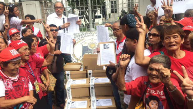 Supporters shows their 1 million signatures gathered to call for former President Ferdinand Marcos burial at the Libingan ng mga Bayani in front of Supreme Court in Manila. RICHARD A. REYES/Philippine Daily Inquirer
