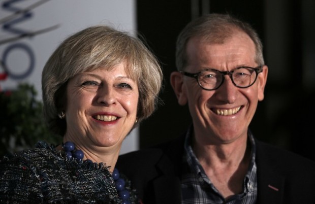 British Prime Minister Theresa May and her husband Philip John May pose for a photograph as they arrive at a hotel close to the International Convention Centre in Birmingham, central England, on October 1, 2016 on the eve of the start of the ruling Conservative party annual conference.  Britain's ruling Conservative party will hold its annual conference in Birmingham from October 2.  / AFP PHOTO / Adrian DENNIS