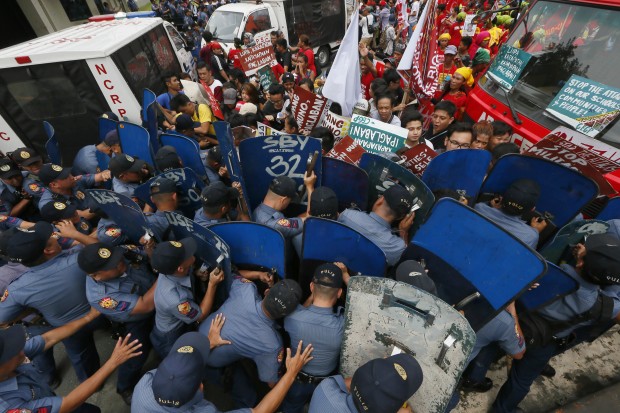 Manila policemen with shields block protesters from approaching the US Embassy on Oct. 19, 2016.  Dozens were hurt when cops forcibly dispersed the protesters calling for an independent foreign affairs policy for the Philippines. (AP)