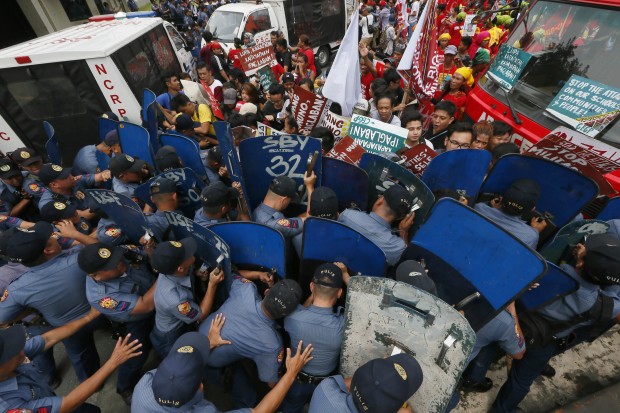 Manila policemen with shields block protesters from approaching the US Embassy on Oct. 19, 2016.  Dozens were hurt when cops forcibly dispersed the protesters calling for an independent foreign affairs policy for the Philippines. AP