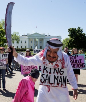 Protestors with Code Pink stage a mock beheading in front of the White House April 20, 2016, Washington, DC to bring attention to the plight of three Saudi Arabian youths, Ali al-Nimr, Dawood al-Marhoon, and Abdullah al-Saher, all sentenced to death for participating in nonviolent protests against the Saudi regime. All three were arrested at different times in 2012, when they were all under the age of 18, and sentenced to death in 2014. / AFP PHOTO / PAUL J. RICHARDS