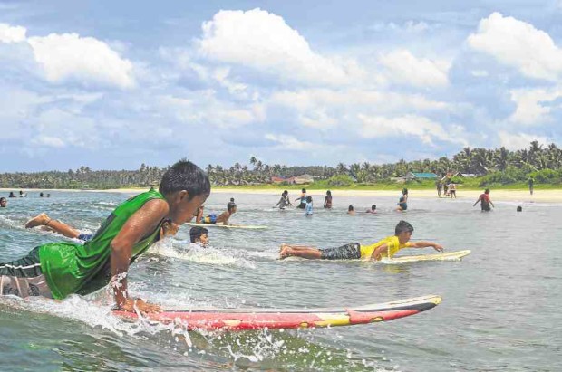 Children in Gubat, Sorsogon, learn to surf so they can guide visitors who flock to their town to enjoy its waves. —REY ANTHONY OSTRIA