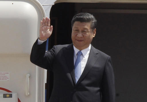 Chinese President Xi Jinping waves from a plane on his arrival at Phnom Penh International Airport in Phnom Penh, Cambodia, Thursday, Oct. 13, 2016. Xi is on a state visit to strengthen the relationships between the two countries and to witness the agreements  to be signed. AP Photo