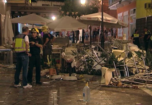In this grab taken from video, provided by Wikono, emergency services stand outside the cafe La Bohemia, after an explosion, in Malaga, Spain, Saturday, Oct. 1, 2016. AP