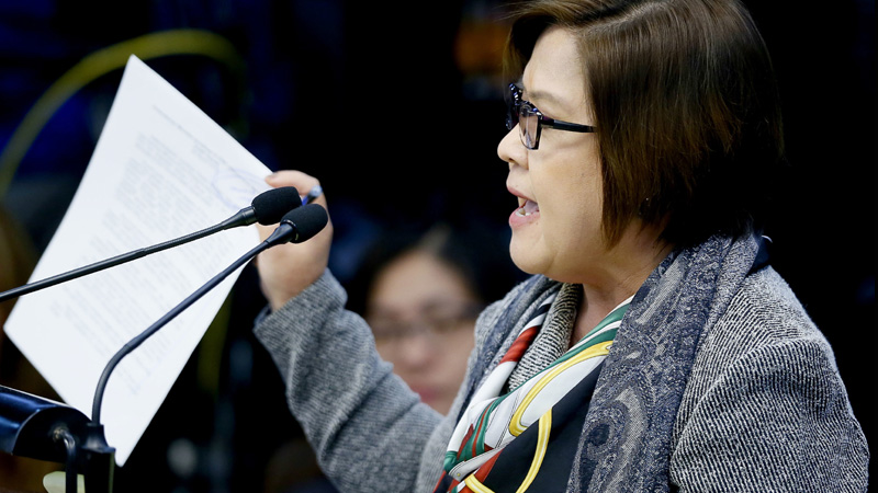 Opposition Senator Leila De Lima holds some documents as she questions witnesses at the resumption of the Philippine Senate probe on extrajudicial killings in the continuing "war on drugs" campaign of President Rodrigo Duterte Monday, Oct. 3, 2016 in suburban Pasay city, south of Manila, Philippines. The Philippine Senate's Committee on Justice and Human Rights, has invited witnesses to look into the possible human rights violations and extrajudicial killings in Davao city when Duterte was still the city mayor as well as the current "war on drugs" campaign by the present administration. (AP Photo/Bullit Marquez)