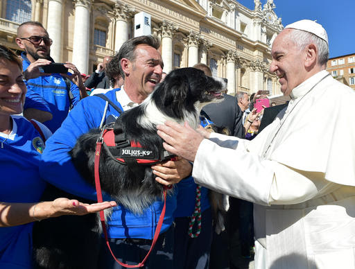 Pope Francis greets a group of dog trainers during his weekly general audience in St. Peter's Square, at the Vatican, Wednesday, Oct. 5, 2016. (L'Osservatore Romano/Pool Photo via AP)