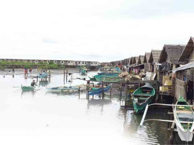 MEMBERS of the Badjao community displaced by the September 2013 siege of Zamboanga City by the Moro National Liberation Front are leaving this row of houses on stilts which the tribal people occupied as temporary shelters after the siege.  JULIE S. ALIPALA/INQUIRER MINDANAO 