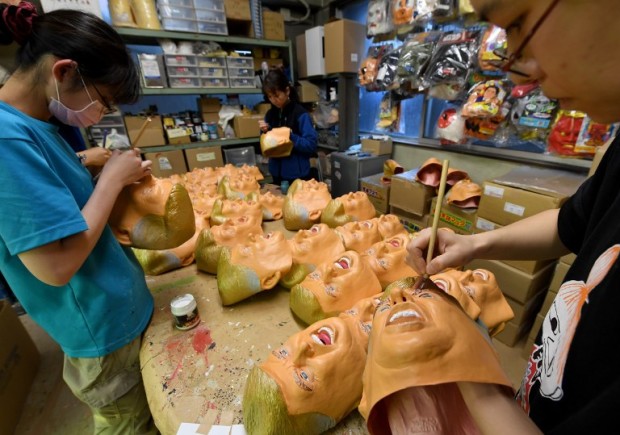 This picture taken on November 22, 2016 shows employees producing rubber masks of US President-elect Donald Trump at the Ogawa Studios mask factory in Saitama, north of Tokyo.  The jury is still out on what Donald Trump's election victory means for close US ally Japan. But at least one local business has emerged a winner. Ogawa Studios, the country's top rubber mask maker, has seen surging demand for their version of the billionaire real-estate magnate since his shock November 8 win. AFP