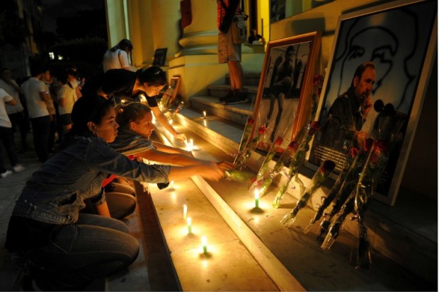 Students light candles in honour of Cuban historic revolutionary leader Fidel Castro a day after his death, at the Havana University in Havana on November 26, 2016.  Cuban revolutionary icon Fidel Castro died late Friday in Havana, his brother, President Raul Castro, announced on national television. Castro's ashes will be buried in the historic southeastern city of Santiago on December 4 after a four-day procession through the country. / AFP PHOTO / Yamil LAGE
