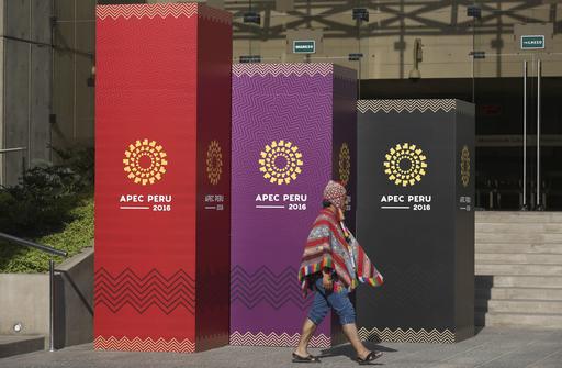 A man dressed in traditional Andean clothes walks past the logo of the APEC 2016 summit in Lima, Peru, Wednesday, Nov. 16, 2016. Lima will host world leaders at this week’s Asian-Pacific economic summit. (AP Photo/Martin Mejia)