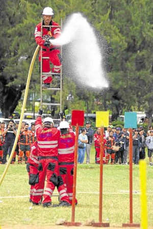 Miners competed at the recent Mine Safety and Environment Week in Baguio City to show their skills in reducing risks at work, like putting out fire in their work sites. —EV ESPIRITU