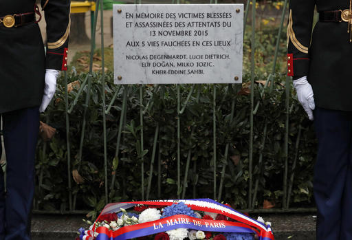A commemorative plaque unveiled by French President Francois Hollande and Paris Mayor Anne Hidalgo is seen next to the "A La Bonne Biere" cafe and the Rue de la Fontaine au Roi street, in Paris, France, Sunday, Nov. 13, 2016, during a ceremony held for the victims of last year's Paris attacks which targeted the Bataclan concert hall as well as a series of bars and killed 130 people. The plaque reads : In memory of the wounded and assassinated victims of the Nov. 13, 2015 attacks. (Philippe Wojazer/Pool Photo via AP)