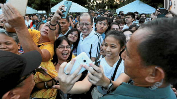 CONCERT SIDESHOW Former President Benigno Aquino III is greeted by supporters who want to have a selfie with him during the Prayer for 8 concert at the Lapu-Lapu monument at Rizal Park in Manila. —GRIG C. MONTEGRANDE