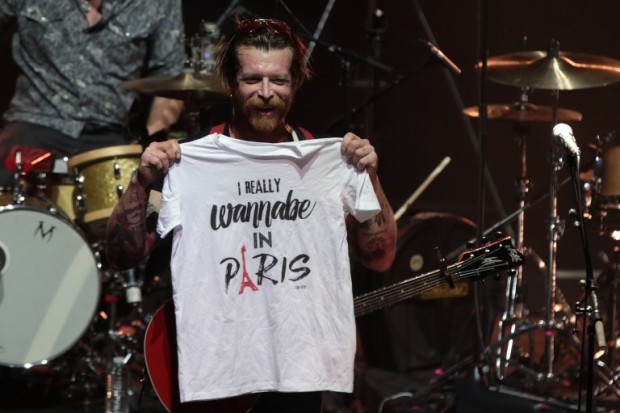 (FILES) This file photo taken on February 16, 2016 shows  Jesse Hughes, the singer of US rock group Eagles of Death Metal, holds a tee-shirt prior to the start of the concert at the Olympia concert hall in Paris, on February 16, 2016.  On November 13, 2015 a series of coordinated attacks by gunmen and suicide bombers in Paris killed at least 128 people in scenes of carnage at the Bataclan, restaurants and the national stadium. / AFP PHOTO / JOEL SAGET