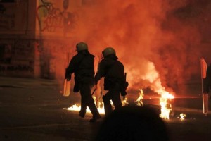 Greek cops walk through firebomb during student riot on Thursday, Nov. 17, 2016