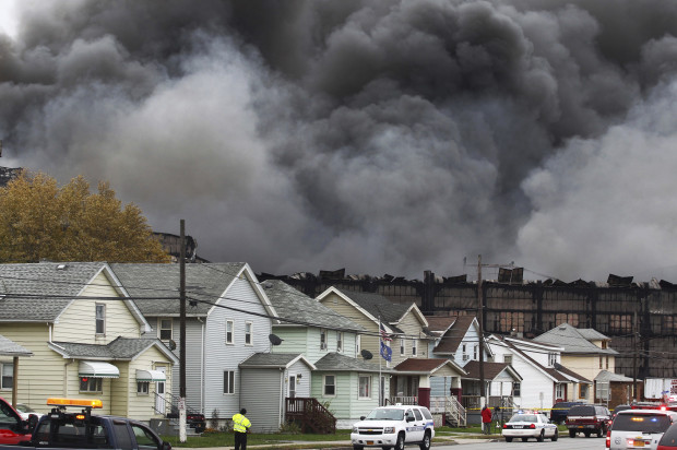 Smoke rises from a fire at a former Bethlehem Steel site, Wednesday, Nov. 9, 2016, in Lackawanna, N.Y. The blaze broke out when a hot light bulb fell onto cardboard inside a business, authorities said. (AP Photo/Jeffrey T. Barnes)