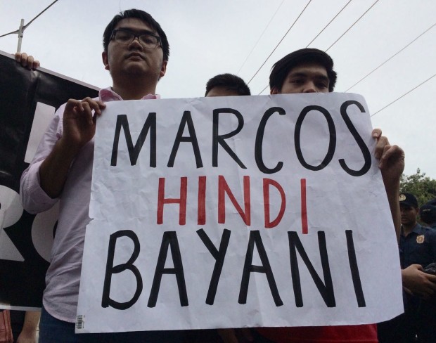 Young anti-Marcos protesters hold signs protesting the burial of former president Ferdinand Marcos at the Libingan ng mga Bayani. Photo by Lyn Rillon/INQUIRER