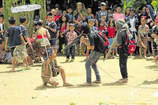 Sangab children reenact scenes when soldiers and communist rebels faced off in their community.