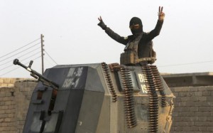 A member of the elite Iraqi counterrorism forces flashes the victory sign.