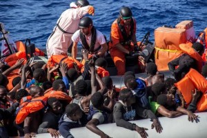 Michele Telaro of MSF with refugees on a boat .