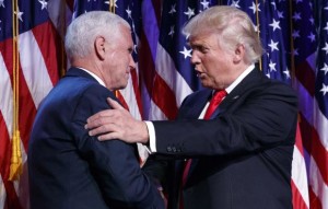 US Vice President-elect Mike Pence shakes hands with President-elect Donald Trump.
