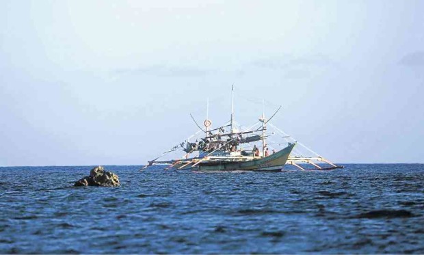A “mother boat” of Filipino fishermen is anchored near the shoal. Photo by Rem Zamora/INQUIRER