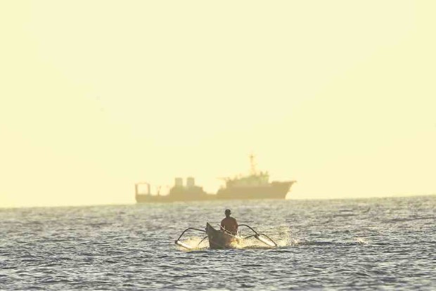 A Chinese Coast Guard vessel keeps watch over the disputed territory. Photo by Rem Zamora/INQUIRER
