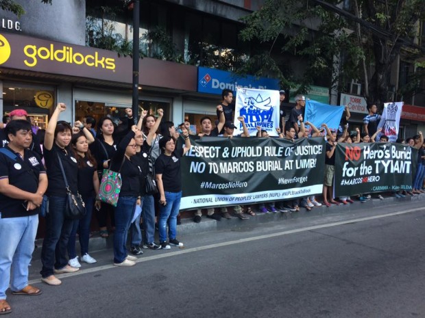 Members of the National Union of Peoples’ Lawyers (NUPL) demonstrate along Espana Boulevard, across the University of Santo Tomas, to protest the Supreme Court's decision allowing the burial of late-dictator Ferdinand Marcos at the Libingan ng mga Bayani. CONTRIBUTED PHOTO
