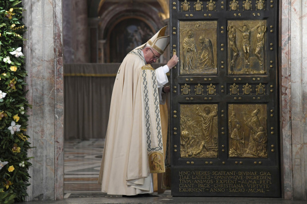 Pope Francis closes the Holy Door of St. Peter's Basilica at the Vatican, Sunday, Nov. 20, 2016. Pope Francis has pulled shut the Holy Door of St. Peter’s Basilica, formally ending the Holy Year of Mercy he declared to highlight that virtue. (Tiziana Fabi/pool photo via AP)