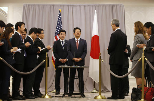 Japanese Prime Minister Shinzo Abe, center, right, listens to questions from members of the press after meeting with President-elect Donald Trump, Thursday, Nov. 17, 2016, in New York. Abe made a stop in New York to meet with the president-elect while en route to an APEC meeting in Lima. AP Photo