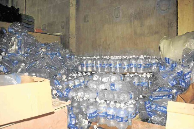 Hundreds of water containers, indicating unusual activity, are among the items found by police inside a warehouse being used as a drug lab in a village in Virac, Catanduanes. —FERNAN GIANAN