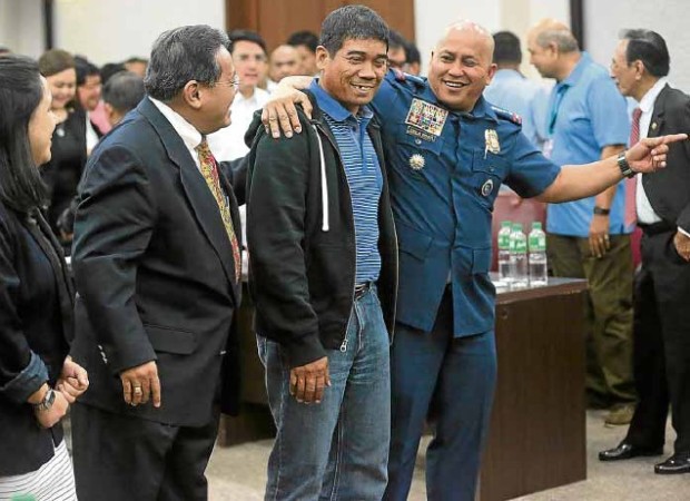 POLICE PROTECTION Ronnie Dayan, lone witness in Thursday’sHouse committee hearing on drug trafficking atNew Bilibid Prison, is returned to police custody after testifying before lawmakers for seven hours. –GRIG C.MONTEGRANDE