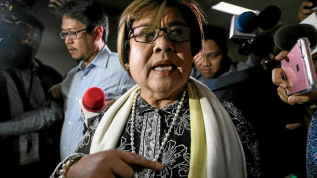 Sen. Leila de Lima leaves her office and the Senate building as news crew sought her for comments on the arrest of her former driver and bodyguard Ronnie Dayan in La Union. INQUIRER PHOTO/LYN RILLON