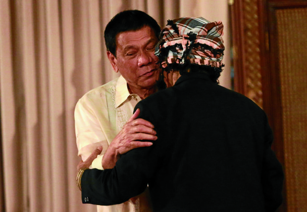 ‘LONG-LOST BROTHERS’ President Duterte and NurMisuari embrace like “long-lost brothers.” The Moro rebel leader,who is accused of instigating the siege on Zamboanga City in 2013, vows to help bring peace to Mindanao and expose Malaysia’s part in theAbu Sayyaf’s kidnapping activities. —JOANBONDOC