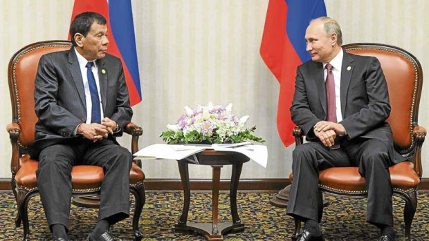 DRIFT TOWARD RUSSIA In his first meeting with Russian President Vladimir Putin in Lima, Peru, President Duterte criticizes the United States and other Western nations as bullies and hypocrites but welcomes strengthening ties with Russia. —AP