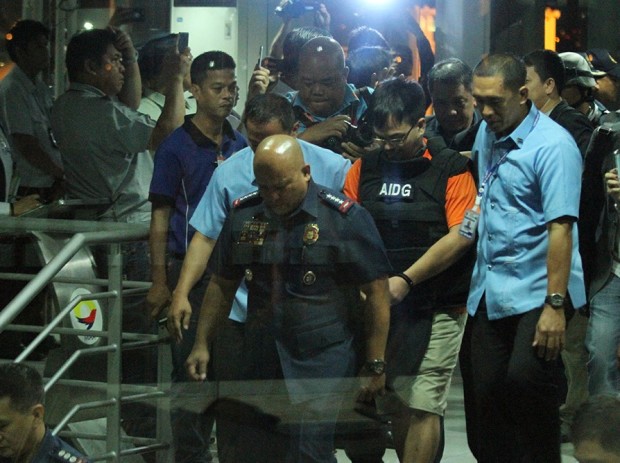 PNP Chief Ronald Dela Rosa and suspected drug lord Kerwin Espinosa descend stairs at the NAIA terminal 2.  Dela Rosa personally fetched Espinosa from the aircraft, having promised to keep him safe, to bring him to Camp Crame. Jeannette I. Andrade
