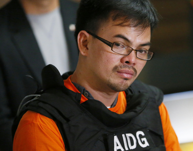 Alleged Filipino drug lord Kerwin Espinosa listens to a question as he is presented to the media upon arrival from Abu Dhabi early Friday, Nov. 18, 2016 at Camp Crame in suburban Quezon city, northeast of Manila, Philippines. Espinosa, whose father Mayor Rolando Espinosa was killed inside his detention cell, told a news conference he will "tell all" those involved in the illegal drug trade in the country. (AP Photo/Bullit Marquez)