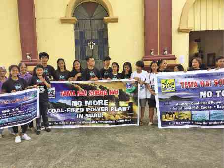 Residents opposed to the construction of another power plant in Sual town in Pangasinan province regroup in front of the church to dramatize their protest against the project. They had wanted to submit a manifesto to President Duterte during a rally but were stopped by police. —GABRIEL CARDINOZA