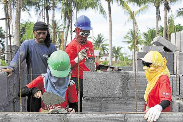 Many houses for survivors of Supertyphoon “Yolanda” had been built by volunteers, like these men building a unit on behalf of the Prudence Foundation, which is building a total of 64 houses on Bantayan Island. —TARRA QUISMUNDO